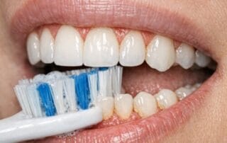 Person flossing between teeth carefully