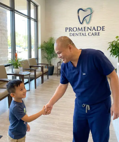 Dr. Bao Nguyen greeting a young patient at Promenade Dental Care in Murrieta, CA