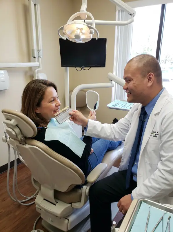 dr bao reviewing a shade guide with a patient