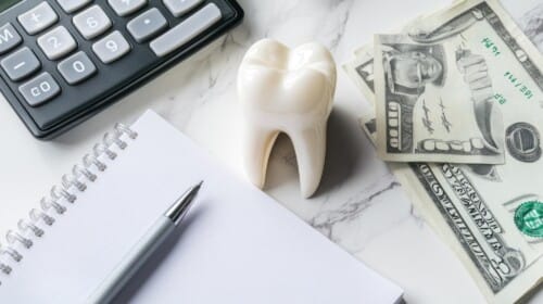 Dentist reviewing oral surgery cost estimate